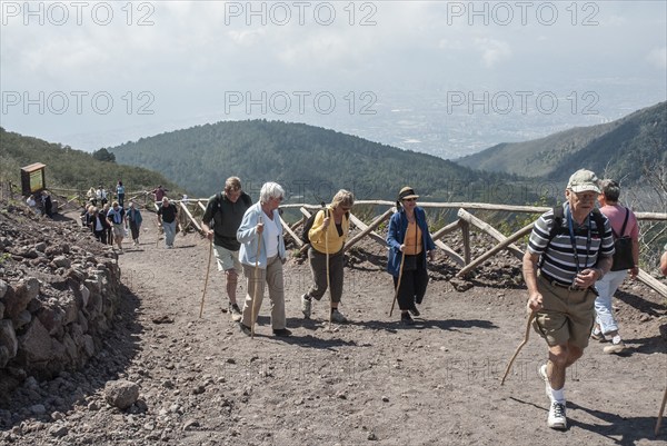 Tourists walking on a path to Vesuvius, near Naples, Parco Nazionale del Vesuvio, Campania, Italy,