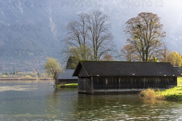 Lake Hallstatt near Steeg. Some boathouses. Autumn, backlight. Lake Hallstatt, Salzkammergut, Upper