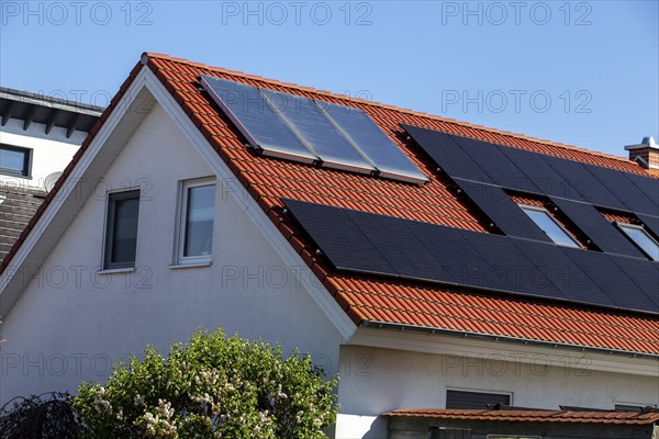 Detached house with photovoltaic system and collectors for solar thermal energy