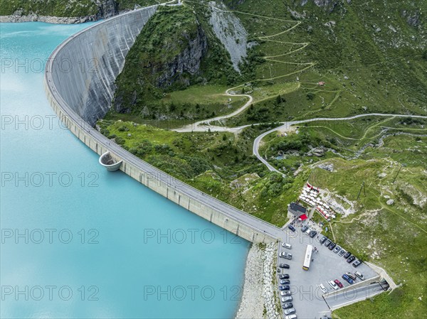 Dam of the Moiry lake, Lac de Moiry, turquoise glacial water, parking lot and restaurant at the