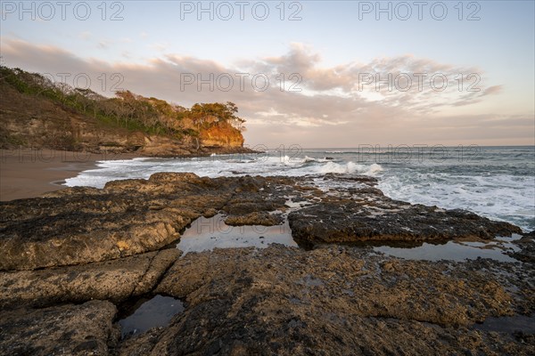 Sandy beach beach with rocks and sea at sunset, Playa Cocalito, coastal landscape, Pacific coast,