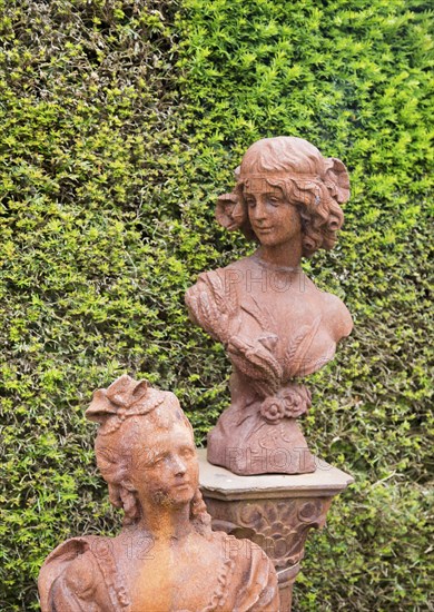 Rusted metal cast iron bust statues female figures, The Walled garden plant nursery, Benhall,