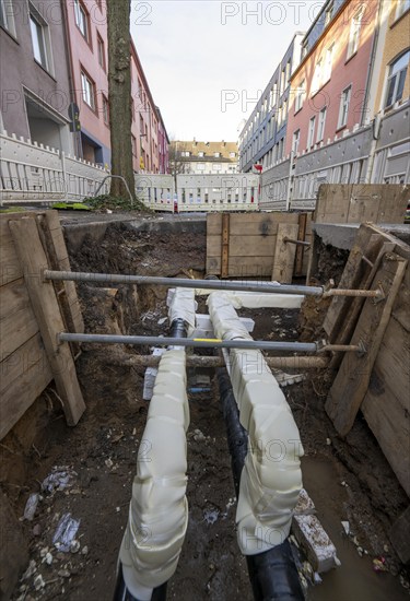 Construction site of a district heating house connection, pipes, insulated, are laid from a central
