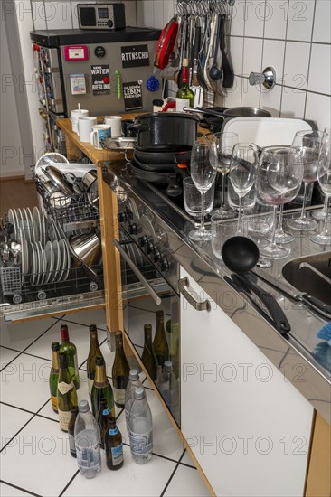 Kitchen after a big dinner, cooking party, dishwasher, full, with cleaned dishes, dirty glasses,