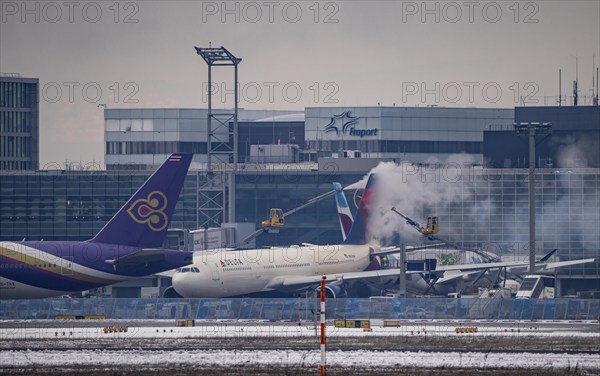 Winter at Frankfurt Main Airport, FRA, Delta aircraft being de-iced at the terminal, Hesse,