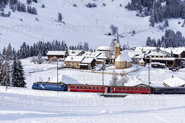 Rhaetian Railway train on the Albula railway Passenger train in the Alps in Bergün, Switzerland,