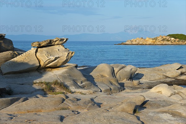 Rocky coast with unique rock formations under a clear sky, Karidi beach, Karydi, Mount Athos in the