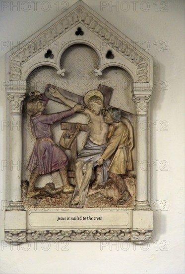 Jesus is nailed to the Cross, stations of the cross, Ufford church, Suffolk, England, UK