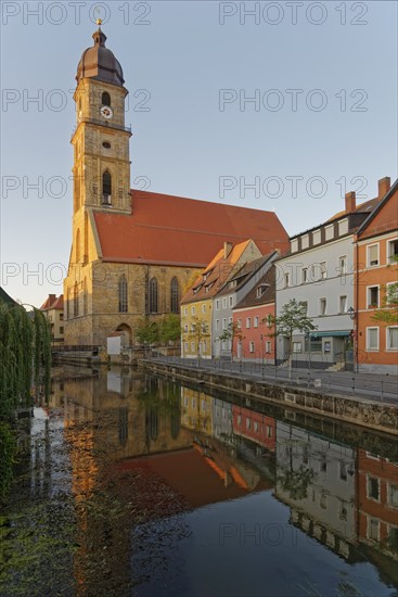 Gentle morning light falls on a historic city view with the church tower of St Martin's Basilica,