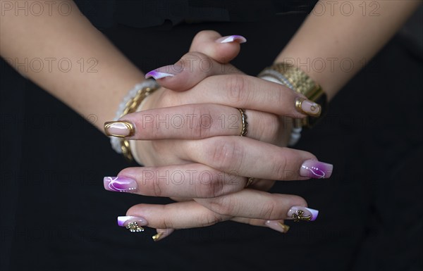 Colourful fingernails of a young woman, on a black background, Baden-Württemberg, Germany, Europe