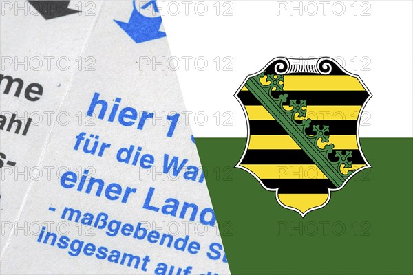 Symbolic image of state election in Saxony: Flag of Saxony and close-up of a ballot paper. The next