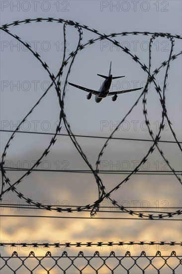Symbolic image security, passenger aircraft taking off, security fence, Stuttgart Airport,