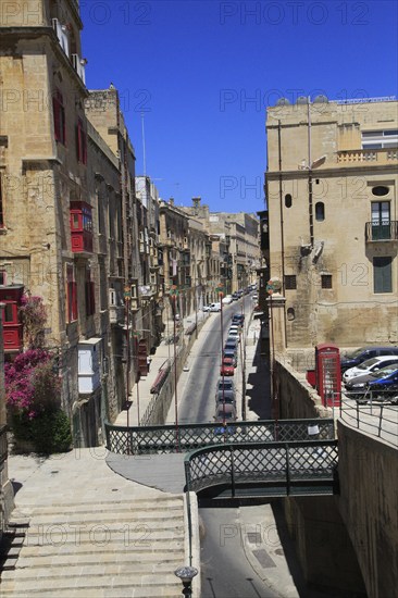 Historic buildings red telephone box iron bridge in city centre of Valletta, Malta, Europe
