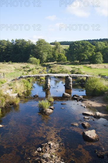 Historic medieval Clapper Bridge at Postbridge, Dartmoor national park, Devon, England crossing the