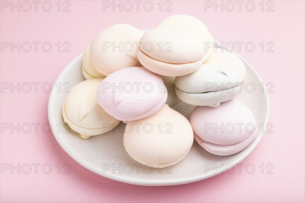 Colored zephyr or marshmallow on pastel pink background. Side view, close up