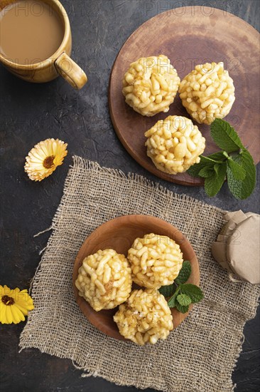 Traditional Tatar candy chak-chak made of dough and honey with cup of coffee on a black concrete