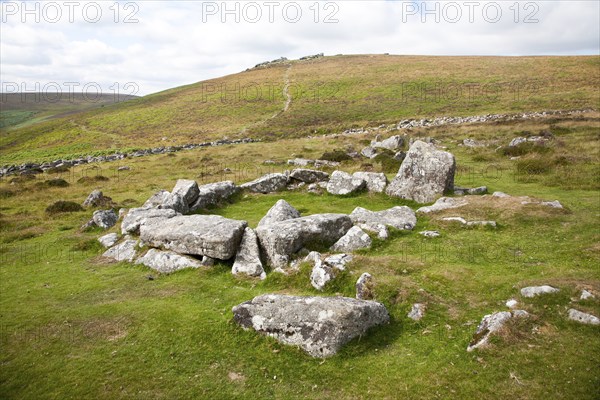Ruins of stone hut circle in the Neolithic enlcosed area of Grimspound, Dartmoor national park,