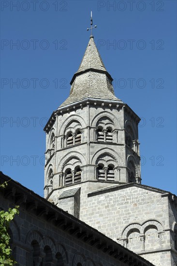 Orcival. Bell tower of the Notre-Dame d'Orcival basilica showcasing Romanesque architecture under a