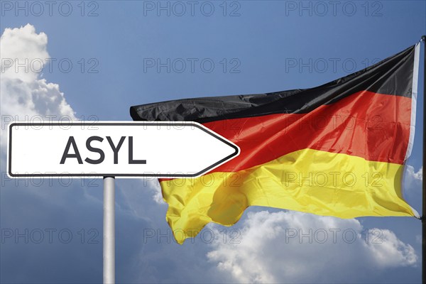 Sign with the inscription Asylum points in the direction of the German flag (symbolic image,