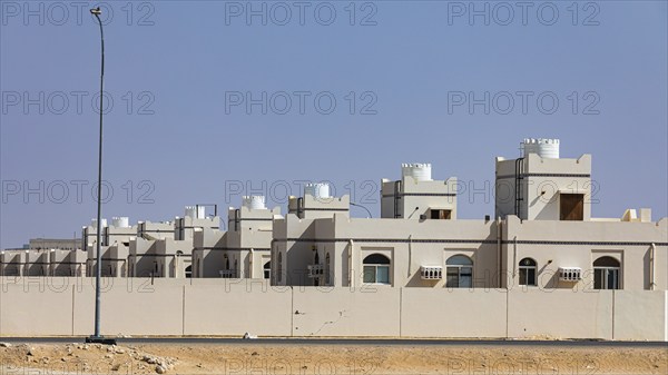 Modern terraced housing estate in the village of Maqshin, on Mascat-Salalah Road, Dhofar Province,