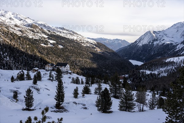 Zufallhütte mountain hut, view of the Martell Valley, snow-covered mountain landscape in winter,