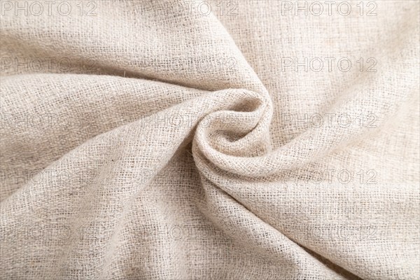 Fragment of white linen tissue. Side view, natural textile background and texture. wave concept,