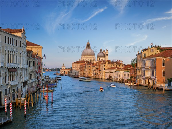Panorama of Venice Grand Canal with boats and Santa Maria della Salute church on sunset from Ponte