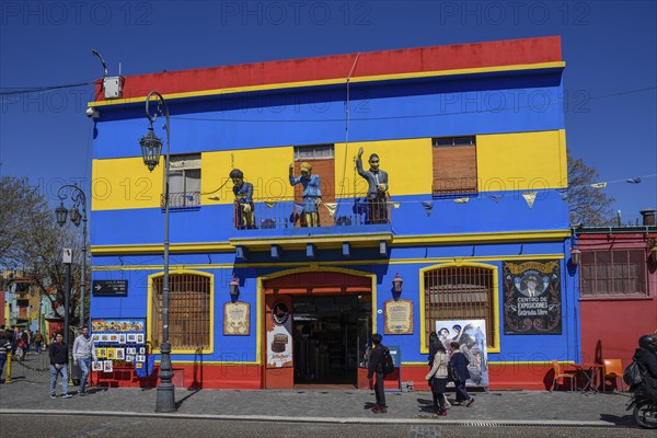 Colourful house facade, on the balcony footballer Diego Maradona, folk heroine Eva Perón and tango