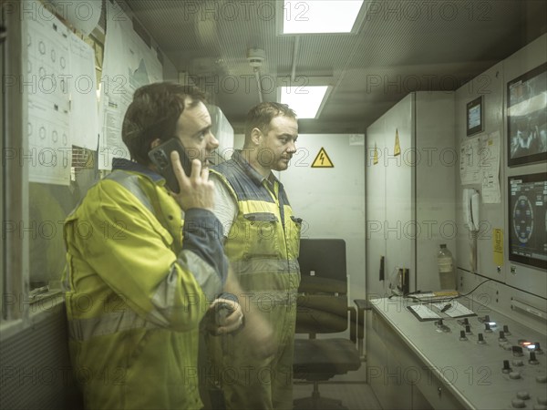 Workers in a control room of the double shield tunnel boring machine in section H53 of the Brenner