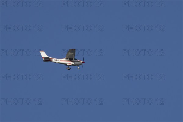Cessna F182Q Skylane aircraft flying in a blue sky, England, United Kingdom, Europe