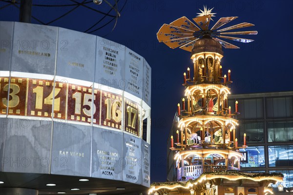 A Christmas pyramid behind the World Time Clock at the Christmas market on Alexanderplatz, Berlin,