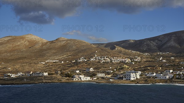 View of a coastal village with hills in the background and blue sky, Kassos Island, neighbouring