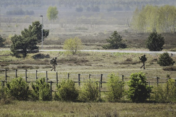 Two armed soldiers, photographed as part of a Bundeswehr exercise with forces from Norway and the