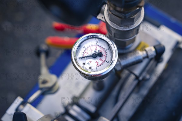A detailed view of a round pressure gauge on a machine, glass fibre construction, Nagold, Black