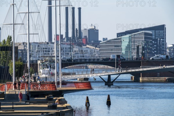 Cyclists on the Cirkelbroen cycle and footpath bridge, over the harbour, in the Christianshavens