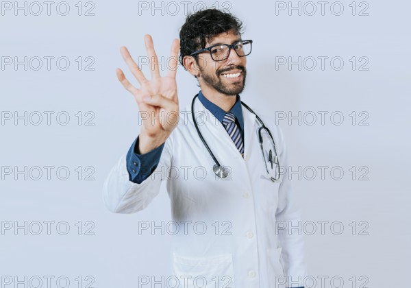 Doctor counting number four isolated. Handsome doctor counting number 4 on isolated background