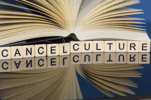 Symbolic image Cancel Culture: Letter cubes show the words Cancel Culture in front of a book