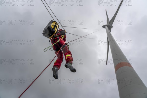 Height rescuers from the Oberhausen fire brigade practise abseiling from a wind turbine from a
