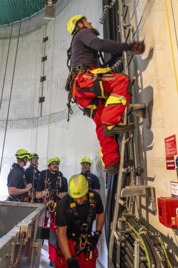 Height rescuers from the Oberhausen professional fire brigade practise abseiling from a wind