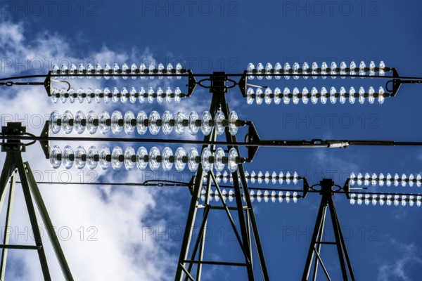 Insulators made of glass on a high-voltage line, they hang on the pylons as a suspension device