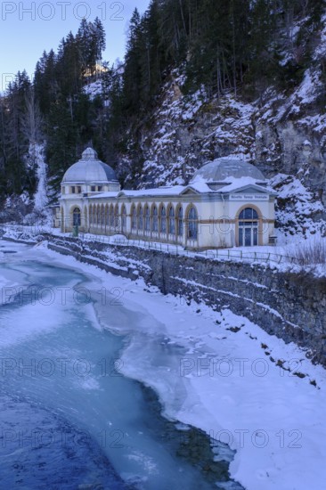 Büvetta Tarasp drinking hall on the Inn or En, Nairs near Scuol in winter, with ice floes, Engadin,