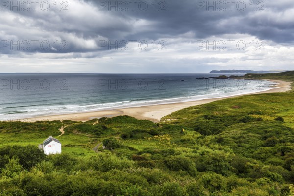 Dune landscape White Park Bay, Whitepark Bay with sandy beach, dramatic rain clouds, coastline,