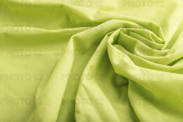 Fragment of green linen tissue. Side view, natural textile background and texture. wave concept,