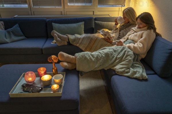 Symbolic image energy saving, cold winter, energy crisis, cold flat, mother and daughter lying on