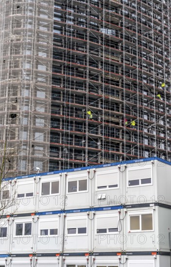 Large construction site, construction of a high-rise residential building, scaffolded shell,