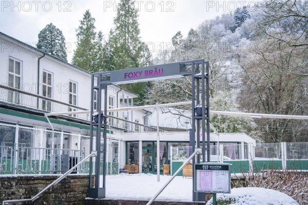 Facade of a modern restaurant in a snow-covered forest landscape, Bad Wildbad, Black Forest,