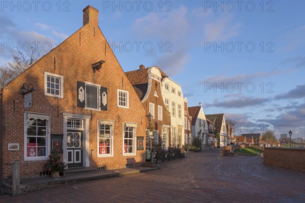 Historic brick houses at the harbour, Greetsiel, Krummhörn, East Frisia, Lower Saxony, Germany,