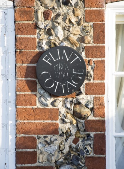 Flint Cottage building detail showing use of red brick and flints at Pettistree, Suffolk, England,