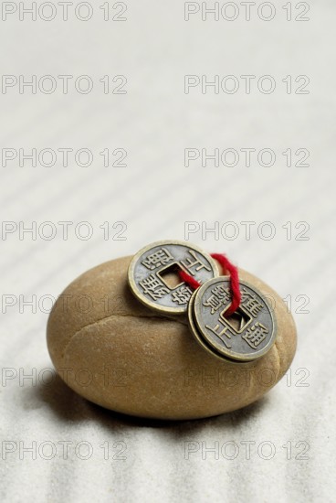 Stone and Chinese lucky coins, coins, lucky coins, lucky coin, coin, in sand