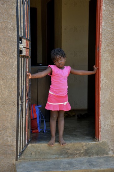 Himba girl in a house in the Himba district of Otuzemba, Otuzemba, Opuwo, Kaokoland, Kunene,